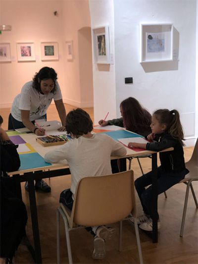 Arianna D’Agostino, illustrator, explains some drawing techniques to children at her “From shape to character” creative table during the Cose Belle Festival 2019.